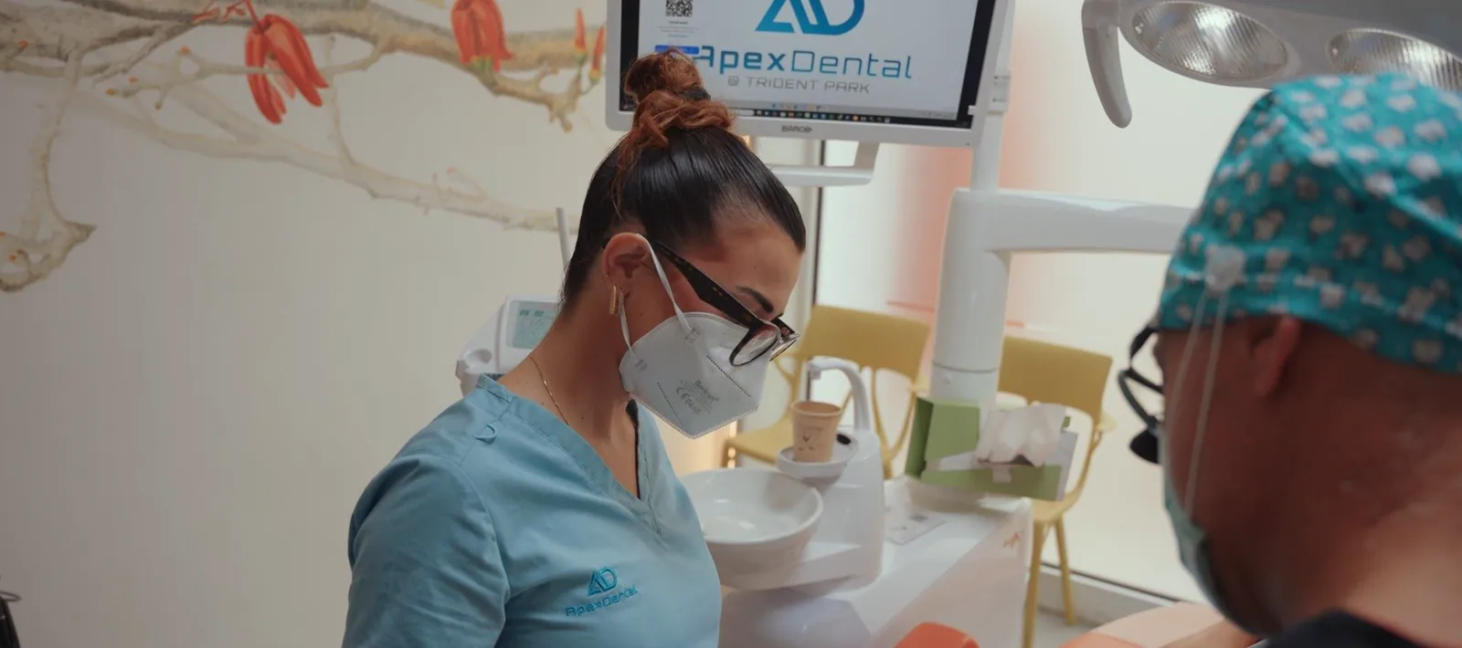 An Apex Dental dentist at work, with magnifying loupes
